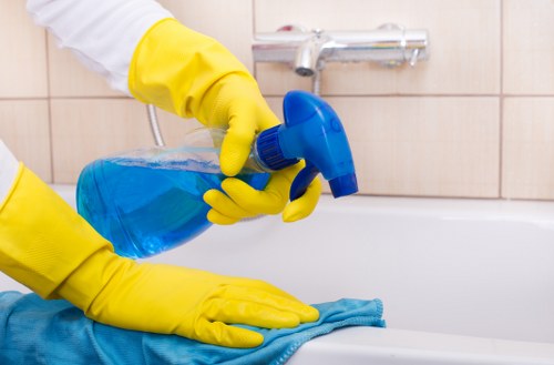 Professional home cleaner working in a TW10 living room